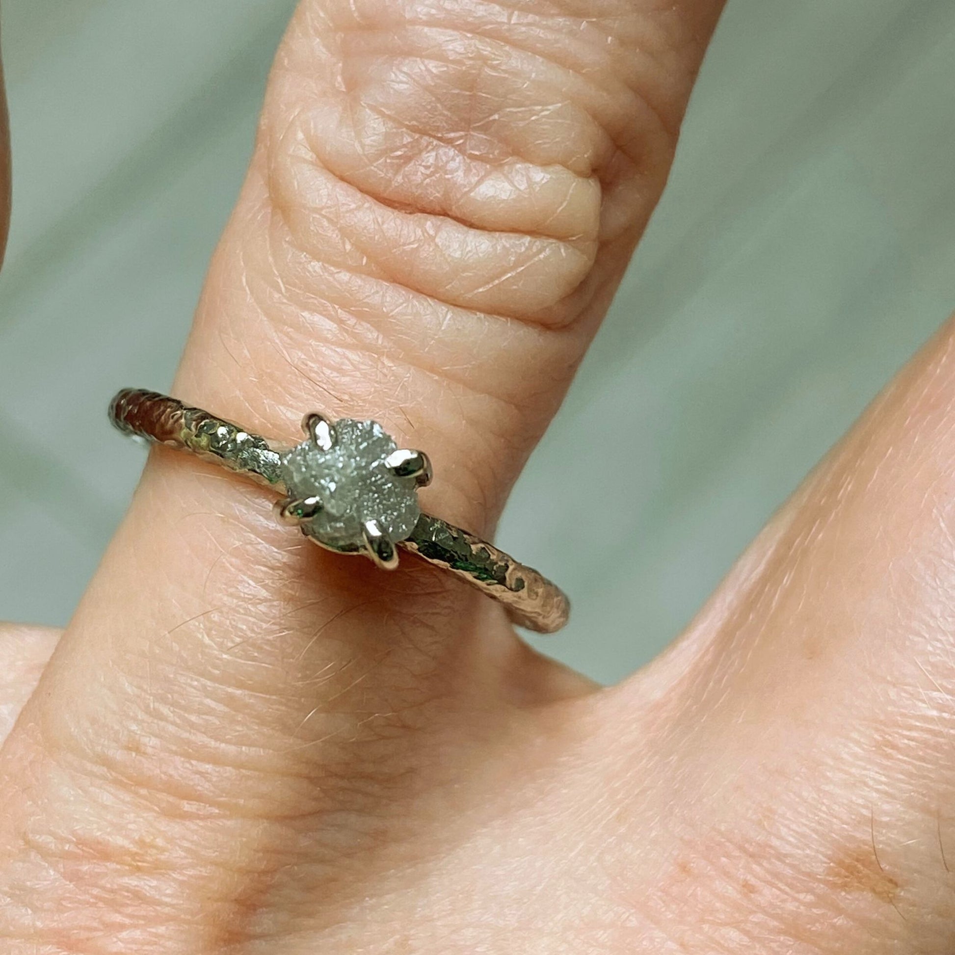 textured 18ct white gold alternative engagement ring with a claw set natural rough uncut diamond.