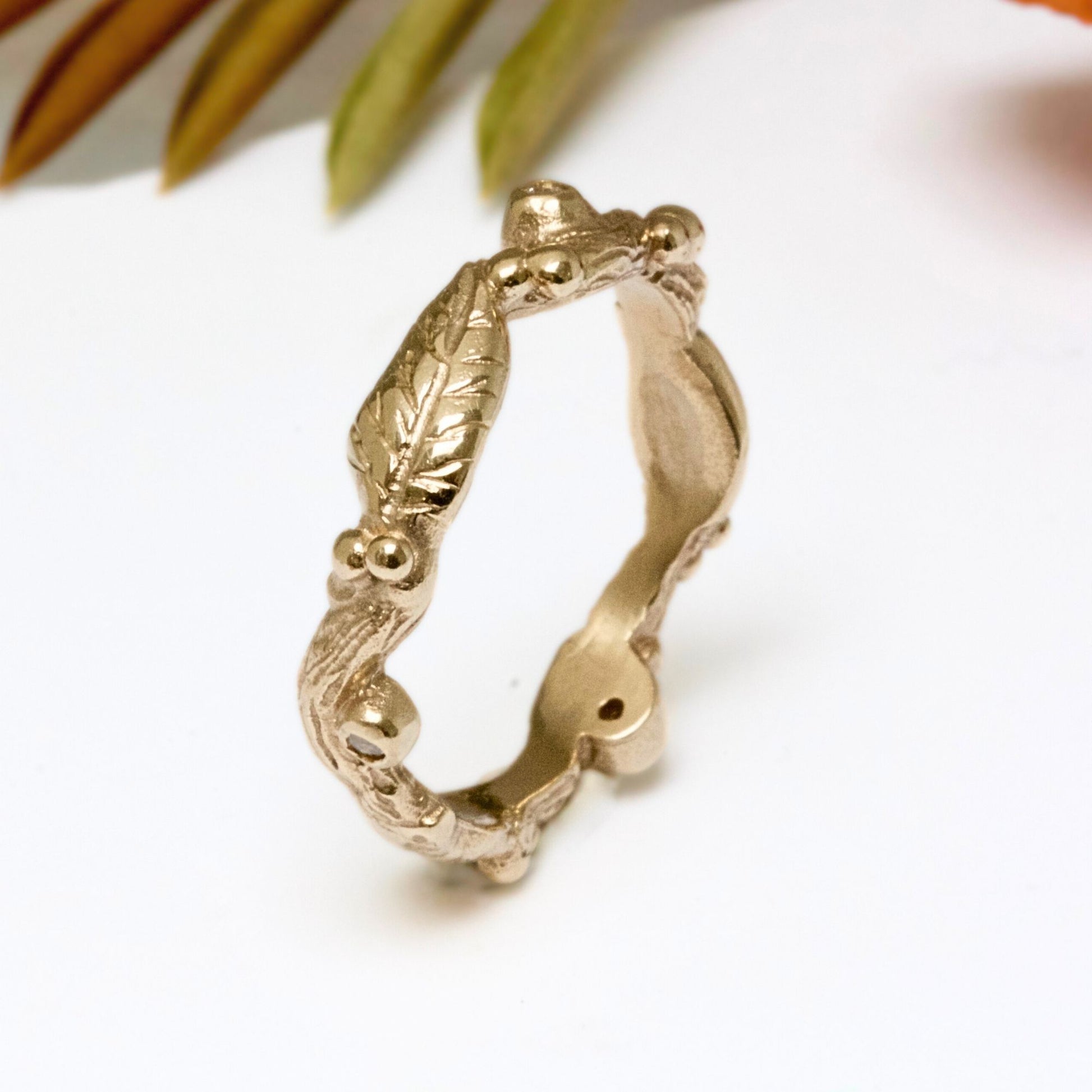 Nature inspired 9ct gold leaf ring, a carved woodland ring with twigs, leaves and berries and studded with champagne, white and salt and pepper natural diamonds. For nature lovers and woodland weddings.