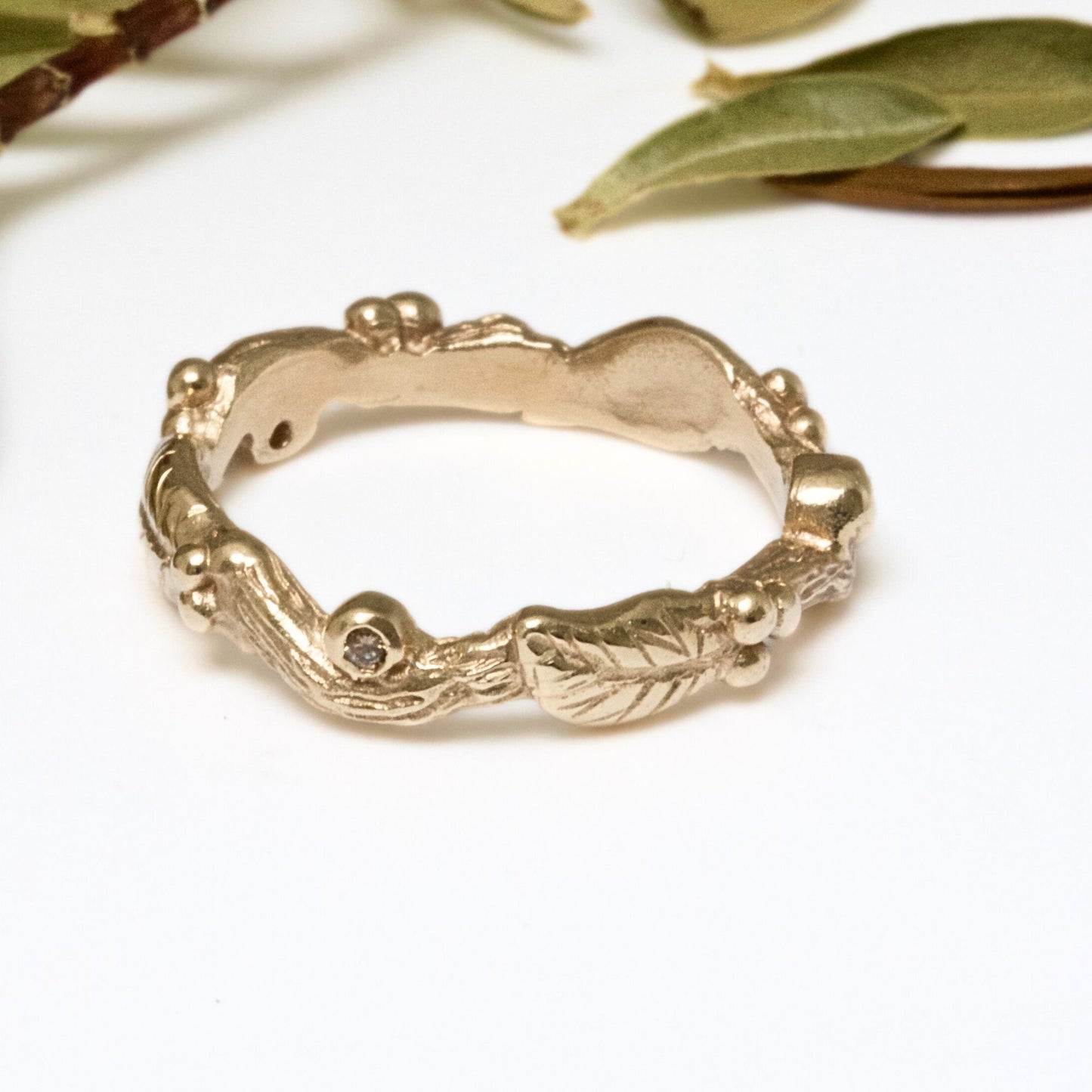 Nature inspired 9ct gold leaf ring, a carved woodland ring with twigs, leaves and berries and studded with champagne, white and salt and pepper natural diamonds. For nature lovers and woodland weddings.