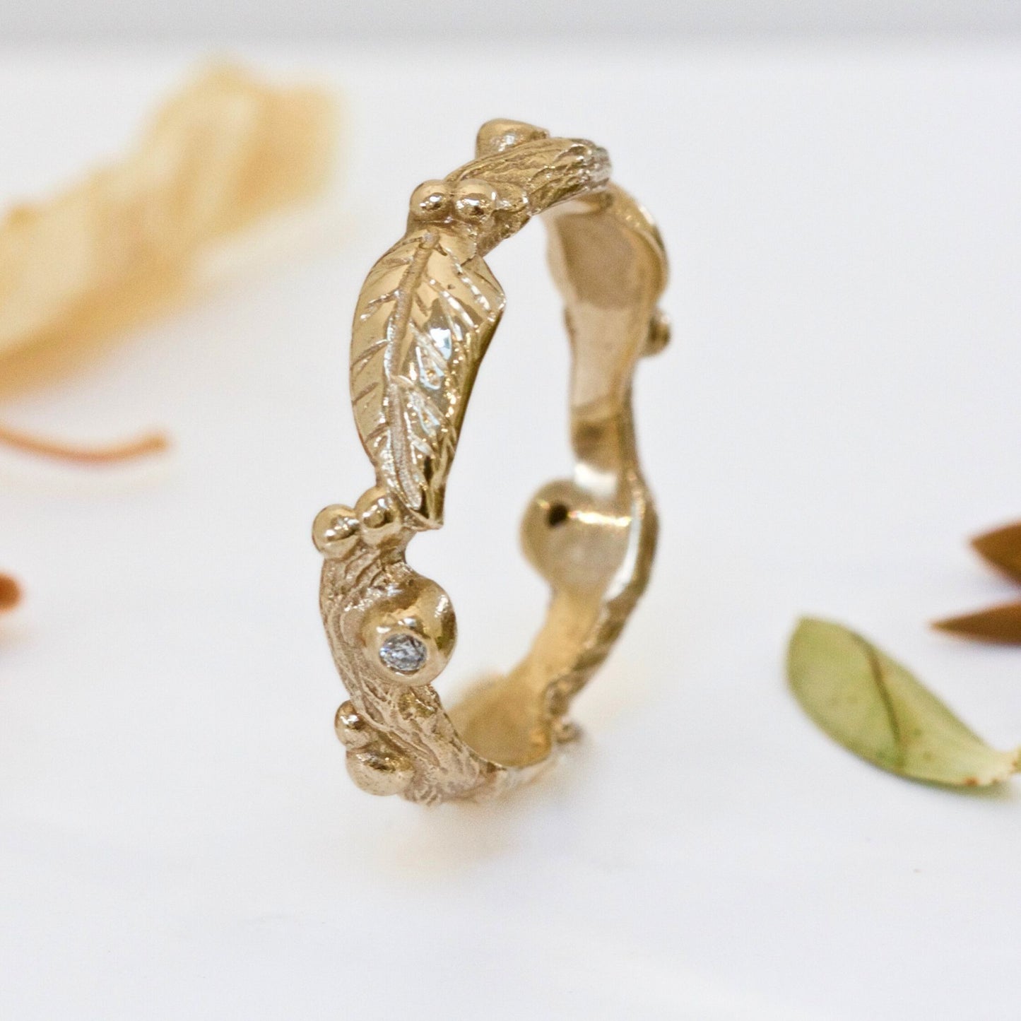 Nature inspired 9ct gold leaf ring, a carved woodland ring with twigs, leaves and berries and studded with champagne, white and salt and pepper natural diamonds. For nature lovers and woodland weddings.