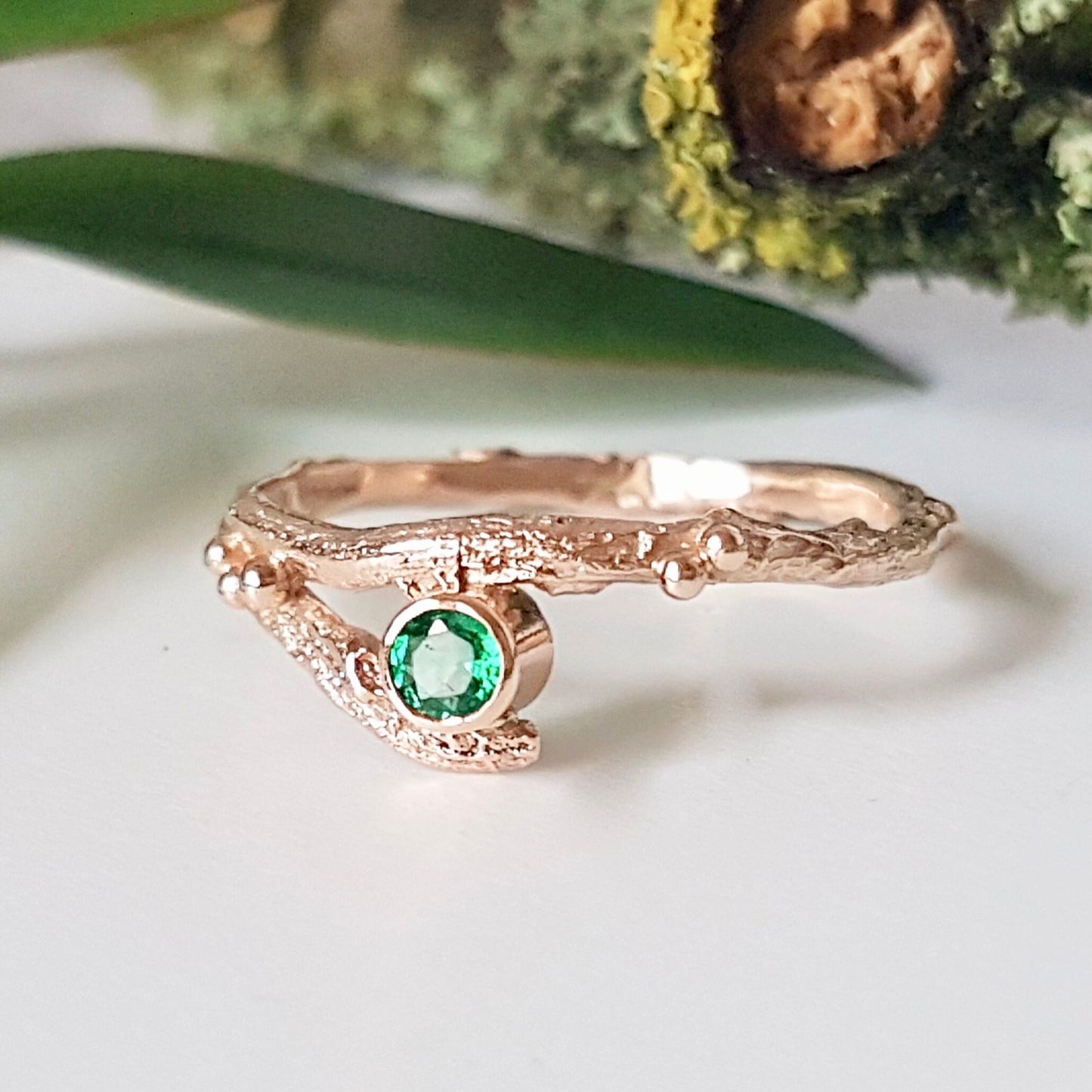 Rose Gold nature inspired twig engagement and wedding ring set. Cast from a real twig in 9ct red gold and set with a natural Emerald.