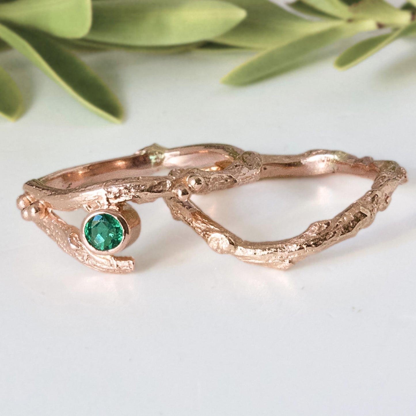 Rose Gold nature inspired twig engagement and wedding ring set. Cast from a real twig in 9ct red gold and set with a natural Emerald.