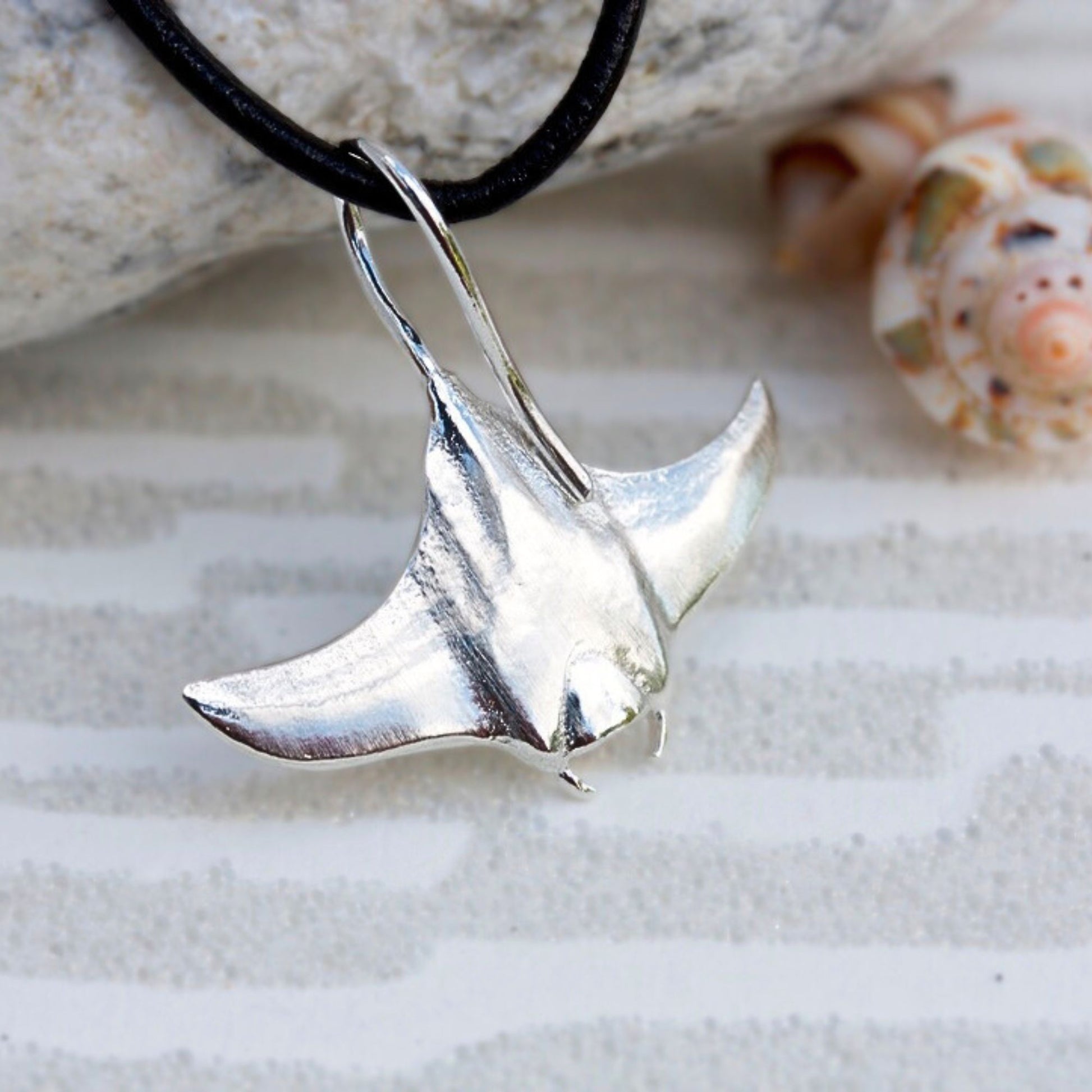 Solid sterling Silver manta ray pendant on an adjustable faux suede thong.